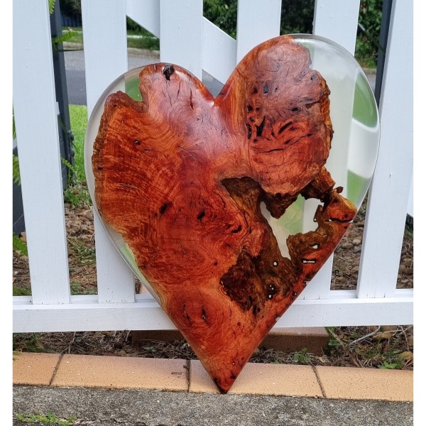 Photograph of a heart carved from a red gum burl and resin by Ugly Burlz